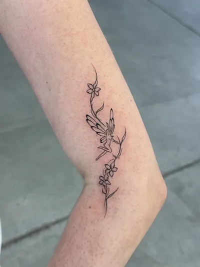 Blossom chain curving across the inner elbow